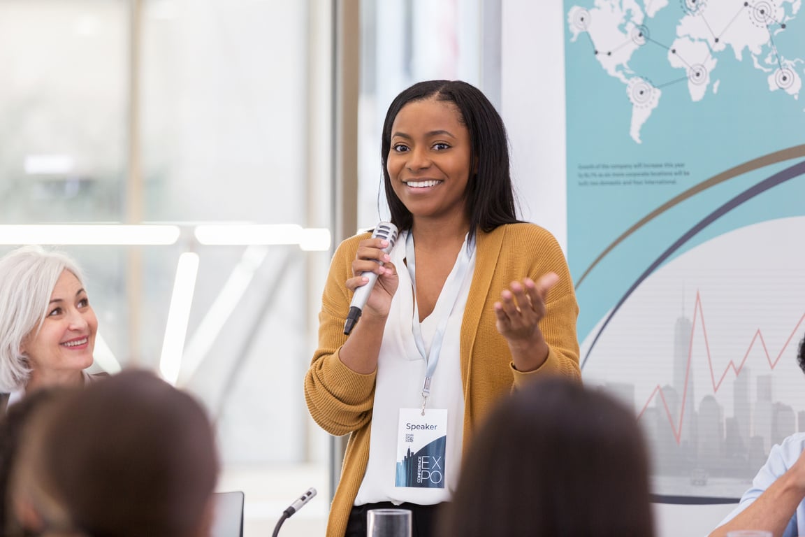 Attractive African American speaker answers question